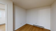 Located at 86 Summercrest Ave in Waynesboro, Virginia, this one-bedroom, one-bathroom unit offers a straightforward and functional layout across a single floor. Warm hardwood flooring runs throughout the living spaces, lending a consistent and clean aesthetic to the interior.

The combined kitchen and living room serves as the heart of the unit, making efficient use of the available space. The kitchen is outfitted with white cabinetry, marble-style countertops, a classic white subway tile backsplash, and a stainless steel sink with a brass-finish faucet. A white electric range with overhead ventilation completes the cooking area, providing all the essentials in a tidy, well-organized arrangement.

The bedroom offers a comfortable, private retreat, featuring warm hardwood floors, neutral white walls, and a window that brings in natural light. A baseboard heating unit ensures year-round comfort. Two closets provide ample storage for the bedroom area.

The bathroom features a full bathtub and shower combination enclosed by white square tile walls, maintaining a clean and classic look.

Throughout the unit, clean white walls, white trim, and warm wood flooring create a cohesive, neutral palette that is easy to personalize. Baseboard heating is present in multiple rooms, ensuring consistent warmth throughout the colder months.