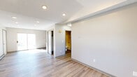 Located at 94 West St in Vernon Rockville, CT, this one-bedroom, one-bathroom unit offers a thoughtfully arranged single-floor layout. Light-toned luxury vinyl plank flooring runs throughout the space, creating a cohesive and clean aesthetic in every room. The living room is bright and open, featuring recessed lighting, a baseboard heating system, and a sliding glass door that opens to an outdoor balcony, allowing natural light to fill the space. The kitchen is a standout feature, showcasing granite countertops, gray shaker-style cabinetry with modern hardware, a mosaic tile backsplash, and stainless steel appliances including a refrigerator and electric range. A dedicated closet off the kitchen provides convenient pantry or storage access. The bedroom is comfortably sized, featuring a window with views of the surrounding greenery, baseboard heating, and a wall-mounted light fixture. A dedicated closet is also accessible from the hallway. The bathroom includes a full-size soaking tub with a combined shower, chrome fixtures, and clean white surround walls. A utility room completes the layout, offering additional functional space. The overall ambiance is clean, updated, and move-in ready.