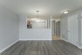 Located on the seventh floor at 245 Lena Cres in Cambridge, Ontario, this well-appointed one-bedroom, one-bathroom unit offers a comfortable and functional layout across a single floor. The entryway, finished with light tile flooring, features a mirrored sliding-door closet that adds a sense of depth and brightness upon arrival.

The open-concept living and dining area is generously sized, filled with natural light from large windows, and finished with warm-toned laminate hardwood flooring. A sliding glass door leads to a private balcony, offering pleasant views of the surrounding neighbourhood. The kitchen is equipped with rich warm-toned cabinetry, light countertops, stainless steel appliances including a fridge and range, and a dishwasher — all set on easy-care tile flooring.

The bedroom is a well-proportioned, serene retreat with a window overlooking the neighbourhood and the same laminate flooring as the main living areas. The full bathroom includes a combined tub and shower unit with clean white finishes. A dedicated in-suite laundry room with a full-size washer and dryer adds everyday convenience. Soft grey walls and white trim throughout create a cohesive, modern aesthetic.
