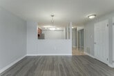 Located on the seventh floor at 245 Lena Cres in Cambridge, Ontario, this well-appointed one-bedroom, one-bathroom unit offers a comfortable and functional layout across a single floor. The entryway, finished with light tile flooring, features a mirrored sliding-door closet that adds a sense of depth and brightness upon arrival.

The open-concept living and dining area is generously sized, filled with natural light from large windows, and finished with warm-toned laminate hardwood flooring. A sliding glass door leads to a private balcony, offering pleasant views of the surrounding neighbourhood. The kitchen is equipped with rich warm-toned cabinetry, light countertops, stainless steel appliances including a fridge and range, and a dishwasher — all set on easy-care tile flooring.

The bedroom is a well-proportioned, serene retreat with a window overlooking the neighbourhood and the same laminate flooring as the main living areas. The full bathroom includes a combined tub and shower unit with clean white finishes. A dedicated in-suite laundry room with a full-size washer and dryer adds everyday convenience. Soft grey walls and white trim throughout create a cohesive, modern aesthetic.