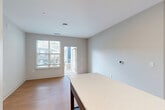 Located at 2320 Clubhouse Station Pl in Waldorf, Maryland, this well-appointed 2-bedroom, 2-bathroom residence offers a thoughtfully designed single-level floor plan with a clean, contemporary aesthetic throughout. Light hardwood-style flooring flows seamlessly across the entire unit, complementing the neutral gray and white color palette.

The open-concept kitchen, dining, and living area serves as the heart of the home. The kitchen is outfitted with white shaker-style cabinetry, a classic subway tile backsplash, white quartz countertops, a center island, and a full suite of stainless steel appliances including a French door refrigerator, electric range, built-in microwave, and dishwasher. Recessed lighting illuminates the space efficiently. The adjacent living and dining area features a private balcony door, allowing natural light to pour in and offering outdoor views.

The spacious primary bedroom includes its own en-suite bathroom, which features a dual-sink vanity with white cabinetry, a walk-in shower with white tile surround, and a large walk-in closet with wire shelving systems. The second bedroom is well-sized with its own closet. The second bathroom includes a single vanity, a tub-shower combination, and matching finishes. A dedicated laundry area and hallway with additional closet storage complete this functional and modern residence.
