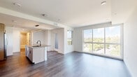 Located in Denver's vibrant 80211 neighborhood, this modern 2-bedroom, 2-bathroom residence offers a thoughtfully designed open-concept layout with clean lines and contemporary finishes throughout. The combined kitchen and living area serves as the heart of the home, highlighted by large floor-to-ceiling windows that flood the space with natural light and frame sweeping views of the surrounding Denver neighborhood and tree canopy. The kitchen is outfitted with light wood cabinetry, stainless steel appliances, a tile backsplash, quartz countertops, and a central island with a matte black faucet — ideal for both cooking and entertaining. Rich hardwood-style flooring flows through the main living areas, adding warmth and continuity. Each bedroom features plush carpeting and generous windows with outdoor views, while the primary bedroom benefits from direct access to a well-appointed bathroom and a walk-in closet equipped with adjustable shelving and hanging systems for efficient organization. A second closet provides additional storage. The bathrooms feature light wood vanities with integrated sinks and modern matte black hardware. Crisp white walls and recessed lighting throughout contribute to a bright, airy ambiance, making this a refined and functional urban residence.