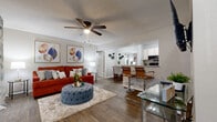 Located at 917 Country Club Park in DeLand, Florida, this single-story home offers four bedrooms and one bathroom within a practical and well-organized floor plan. The open-concept living and dining area serves as the heart of the home, featuring durable hardwood-style flooring, a textured ceiling, and a ceiling fan with integrated lighting. The living space flows seamlessly into a breakfast bar-style dining area with bar seating, offering a casual and connected atmosphere. Framed wall art adds a decorative touch to the neutral-toned walls throughout.

The galley-style kitchen is efficiently laid out with white cabinetry, a double-basin sink, and black appliances including a refrigerator and electric range. A foyer area near the front entrance provides additional functional space and connects to an in-unit laundry area.

The bedrooms are carpeted and each includes a ceiling fan and window with natural light. The primary bedroom is a comfortable size with ample room for furnishings. The shared bathroom features a single-sink vanity with white cabinetry, a large mirror, and overhead lighting, maintaining a clean and bright aesthetic. This home offers practical living in a convenient DeLand location.