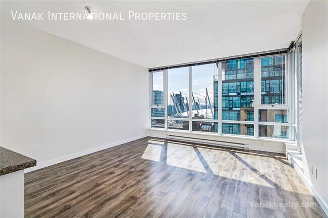 Building Photo - Bright Downtown 1-Bedroom + Large Den with Parking
