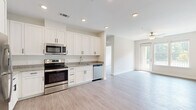 Located at 4121 Concord Creek Place in Richmond, VA, this single-story 2-bedroom, 2-bathroom residence offers a thoughtfully designed open-concept layout with consistent light-toned luxury vinyl plank flooring throughout. The kitchen serves as a focal point, featuring crisp white shaker cabinetry, granite countertops, stainless steel appliances including a refrigerator, electric range, microwave, and dishwasher, all illuminated by recessed lighting. The kitchen flows seamlessly into the living room, which is brightened by natural light and features a ceiling fan, as well as a glass door leading to a private balcony with outdoor views of surrounding greenery. Both bedrooms are generously sized, offering ceiling fans and ample natural light. The spacious primary bedroom connects to a full en-suite bathroom with a granite-topped double vanity, soaking tub, and direct access to a walk-in closet fitted with wire shelving. A second full bathroom mirrors the same clean, modern aesthetic. Two closets throughout the home provide practical storage solutions. The entrance and hallway connect the spaces efficiently, completing a functional and cohesive floor plan suited for comfortable everyday living.
