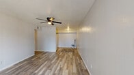 Located at 950 Buena Vista St in Amarillo, Texas, this well-appointed 2-bedroom, 3-bathroom unit offers a functional and modern layout across a single floor. The living room is a welcoming, open space featuring wood-look laminate flooring, a ceiling fan with light fixture, and a sliding glass door with vertical blinds that invites natural light and provides access to an outdoor area. The neutral grey walls and textured ceilings create a clean, contemporary aesthetic throughout.

The spacious primary bedroom is generously sized, outfitted with a ceiling fan, a window with exterior views, and access to a dedicated walk-in closet featuring dual hanging rods and built-in storage. The second bedroom is similarly finished with matching flooring, a window for natural light, and a neutral color palette.

The three bathrooms are consistently styled with dark-toned cabinetry, white countertops, vanity lighting above large mirrors, and tile wainscoting. The wood-look flooring continues seamlessly through the hallway, connecting all areas of the unit in a cohesive flow.

Throughout the space, the consistent use of light grey tones, modern flooring, and practical fixtures creates a clean and comfortable environment well-suited for everyday living.