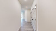 This well-appointed 2-bedroom, 2-bathroom residence offers a thoughtfully designed single-floor layout that maximizes comfort and functionality. Light-toned luxury vinyl plank flooring runs throughout the entire space, creating a cohesive and contemporary aesthetic.

The open-concept kitchen and living area serves as the heart of the home. The kitchen is outfitted with two-tone cabinetry — soft grey uppers paired with sage green lowers — complemented by a blue subway tile backsplash, a large white quartz waterfall island with an undermount sink, pendant lighting, and a full suite of stainless steel appliances including a refrigerator with ice maker, range, and microwave.

The primary bedroom is a well-sized retreat filled with natural light from multiple windows and equipped with a ceiling fan. It connects to a dedicated walk-in closet featuring wire shelving. The second bedroom is equally bright, with tall windows that invite outdoor views and a ceiling fan overhead.

The hallway is clean and modern, lined with paneled doors accented by matte black hardware. The bathroom features floor-to-ceiling grey subway tile in the tub/shower surround, a soaking tub, and matte black fixtures throughout, adding a refined contrast to the crisp white walls and light tile floors.