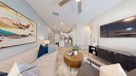 Located on Alexis Ave in Daytona Beach, FL, this 2-bedroom, 2-bathroom residence offers a thoughtfully designed single-floor layout that maximizes comfort and functionality. The open-concept kitchen and living area serves as the heart of the home, where crisp white cabinetry, subway tile backsplash, stainless steel appliances, and a granite-topped center island with bar seating create an inviting and practical kitchen space. Pendant lighting accents the island, while light wood-style flooring flows seamlessly throughout. The living room is bright and airy, featuring vaulted ceilings, a ceiling fan, large windows with sheer curtains that invite natural light, and a stylish accent wall in a soft teal hue. The primary bedroom is a comfortable retreat with vaulted ceilings, a ceiling fan, natural light from dual windows, and a dedicated closet. The second bedroom is equally well-sized and bright. Both bathrooms are finished with neutral tile, white vanities with granite countertops, and wood-look flooring — one featuring a glass-enclosed walk-in shower, the other a full soaking tub with tiled surround. A dedicated closet provides additional storage. The overall aesthetic is clean, modern, and cohesive throughout.