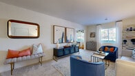 Located at 8100 Garners Ferry Rd in Columbia, SC, this single-floor residence offers a thoughtfully designed layout with 2 bedrooms, 2 bathrooms, a sunroom, and a dedicated office space. The living room is bright and welcoming, featuring large windows that invite natural light and views of the surrounding greenery. Soft carpeting and neutral walls create a versatile backdrop throughout the main living areas. The kitchen is equipped with wood-toned cabinetry, dark appliances including a refrigerator, range, and microwave, and flows naturally into a dedicated dining area with tile flooring and track lighting overhead. The primary bedroom is a comfortable retreat featuring a ceiling fan, large window with outdoor views, and plush carpet flooring. The second bedroom is similarly carpeted and well-lit, with a sizable window framing serene tree-lined views. Both bathrooms are clean and functional, with one featuring a soaking tub and granite-style countertops. The sunroom offers an abundance of natural light with windows on multiple sides, making it an ideal reading nook or lounge. The office provides a quiet, dedicated workspace. Overall, the residence delivers a practical yet inviting atmosphere throughout.