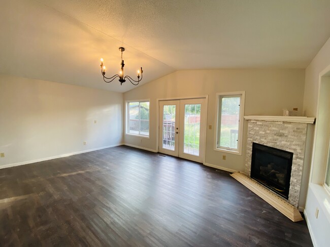 Family Room with vaulted ceilings and fire place. - 4219 Boone Ave N