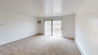 Located at 3372 Van Horn Rd in Trenton, Michigan, this one-bedroom, one-bathroom unit offers a well-utilized, single-floor layout designed for comfortable everyday living. The open-concept main area seamlessly connects the living room, dining space, and kitchen, creating a cohesive and functional flow throughout. The living room features neutral carpet flooring, a ceiling fan, a wall-mounted air conditioning unit, and a sliding glass door that opens to a private balcony with outdoor views of surrounding greenery. Baseboard heating runs along the perimeter, ensuring year-round comfort. The galley-style kitchen is efficiently arranged with dark wood cabinetry on both sides, light granite-style countertops, a stainless sink, and white appliances including a range and refrigerator, all set atop durable hardwood-style flooring. The spacious primary bedroom is carpeted and bright, featuring a large window with vertical blinds, a ceiling fan, and two louvered closet doors offering generous storage. The bathroom includes a wide vanity with dual sinks, granite-style countertops, dark wood cabinetry, and mirrored medicine cabinets. Throughout the unit, four closets provide exceptional storage capacity. The clean, neutral palette and practical layout make this a functional and inviting space.