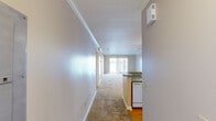 This well-appointed 2-bedroom, 2-bathroom residence in Slidell, Louisiana offers a comfortable and functional single-floor layout. A welcoming hallway leads into the open-concept living and dining area, where soft carpeting, crown molding, and a sliding glass door frame a stunning waterfront view, flooding the space with natural light and providing direct outdoor access.

The kitchen is efficiently designed with warm oak cabinetry, granite-style countertops, a breakfast bar peninsula, hardwood flooring, and white appliances including a range, built-in microwave, and refrigerator. Flush-mount ceiling lighting keeps the space bright and practical.

Both bedrooms are generously proportioned, carpeted, and feature vertical-blind windows that allow for natural light and privacy. The primary bedroom includes louvered closet doors and a wall-mounted thermostat for independent climate control.

The two bathrooms are finished consistently with oak vanities, granite-style countertops, and hardwood floors. One bathroom features a walk-in shower with glass doors, while the second offers a full tub-shower combination. Neutral warm-beige tones throughout the unit create a cohesive, calm aesthetic that is both inviting and easy to personalize.