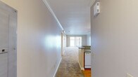 This well-appointed 2-bedroom, 2-bathroom residence in Slidell, Louisiana offers a comfortable and functional single-floor layout. A welcoming hallway leads into the open-concept living and dining area, where soft carpeting, crown molding, and a sliding glass door frame a stunning waterfront view, flooding the space with natural light and providing direct outdoor access.

The kitchen is efficiently designed with warm oak cabinetry, granite-style countertops, a breakfast bar peninsula, hardwood flooring, and white appliances including a range, built-in microwave, and refrigerator. Flush-mount ceiling lighting keeps the space bright and practical.

Both bedrooms are generously proportioned, carpeted, and feature vertical-blind windows that allow for natural light and privacy. The primary bedroom includes louvered closet doors and a wall-mounted thermostat for independent climate control.

The two bathrooms are finished consistently with oak vanities, granite-style countertops, and hardwood floors. One bathroom features a walk-in shower with glass doors, while the second offers a full tub-shower combination. Neutral warm-beige tones throughout the unit create a cohesive, calm aesthetic that is both inviting and easy to personalize.