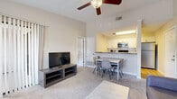 This 1-bedroom, 1-bathroom unit offers a thoughtfully designed, single-floor layout that maximizes functionality across its compact footprint. The open-concept living and dining area is anchored by plush wall-to-wall carpeting, elevated ceilings with a ceiling fan, and a sliding glass door fitted with vertical blinds that leads to a private balcony. A large window further fills the space with natural light, enhancing the bright, neutral-toned interior.

The kitchen is positioned adjacent to the dining area and features white cabinetry, granite-style countertops, a subway tile backsplash, hardwood-style flooring, and a full suite of stainless steel appliances including a refrigerator, range, microwave, and dishwasher.

The bedroom is a comfortable retreat with plush carpeting, a ceiling fan, and a sliding glass door offering outdoor access and natural light. A dedicated closet and direct access to the bathroom add practical convenience. The bathroom includes a shower/tub combination, a vanity with a granite-style countertop, and hardwood-style flooring.

Additional highlights include a dedicated closet for storage and a private balcony, making this a well-rounded and efficiently laid-out living space.