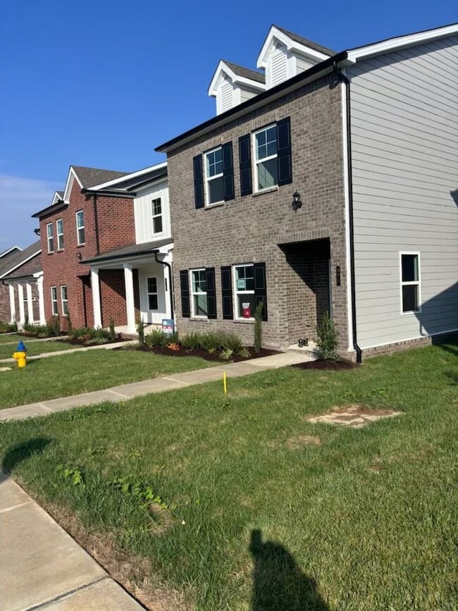 Building Photo - **BE THE LUCKY ONE TO LIVE IN THIS 2024-BUILT END-UNIT TOWNHOME IN A RESORT-STYLE COMMUNITY**