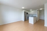 Located at 426 Central Ave in London, Ontario, this efficiently designed single-floor unit offers a clean, modern aesthetic throughout. The open-concept layout maximizes the available space, seamlessly connecting the living area and kitchen into one functional zone.

The kitchen is a standout feature, outfitted with sleek white cabinetry extending to the ceiling for ample storage, grey composite countertops, and stainless steel appliances including a refrigerator, electric range with over-the-range microwave, and a dishwasher. A central kitchen island with a grey countertop provides additional workspace and serves as a natural divider within the open floor plan.

The living area is bright and airy, with a large window that invites natural light and offers views of the surrounding greenery. Light hardwood flooring runs throughout the main space, complementing the crisp white walls and contributing to a clean, contemporary feel. A baseboard heater beneath the window ensures year-round comfort.

The bathroom is finished in an all-white palette, featuring white tile flooring, a full soaker tub with shower, and brushed nickel fixtures, creating a simple and functional space. Built-in sliding storage along one wall adds practical organization to the unit. Overall, this space offers a well-appointed, minimalist living environment.