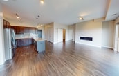 This contemporary apartment in Apex offers 1280 square feet of thoughtfully designed living space. The heart of the home is an open-concept living area, showcasing a sleek gas fireplace and large windows that flood the space with natural light. Sliding glass doors lead to a balcony, providing scenic outdoor views.

The gourmet kitchen is a chef's dream, featuring rich wood cabinetry, granite countertops, and stainless steel appliances. A central island with a breakfast bar adds functionality and style. The kitchen's blue subway tile backsplash adds a pop of color to the warm wood tones.

The apartment boasts three bedrooms, including a primary suite measuring 160 square feet. All bedrooms feature plush carpeting for comfort. The three bathrooms are modern and well-appointed, with one showcasing a double vanity with granite countertops and ample storage.

Throughout the apartment, you'll find a harmonious blend of materials, including gleaming hardwood floors in the main living areas and neutral-toned walls. Track lighting and designer light fixtures add ambiance and functionality. Two closets provide additional storage space.

This single-story apartment combines style, comfort, and convenience in a well-planned 1280 square foot layout, perfect for modern living in Apex.