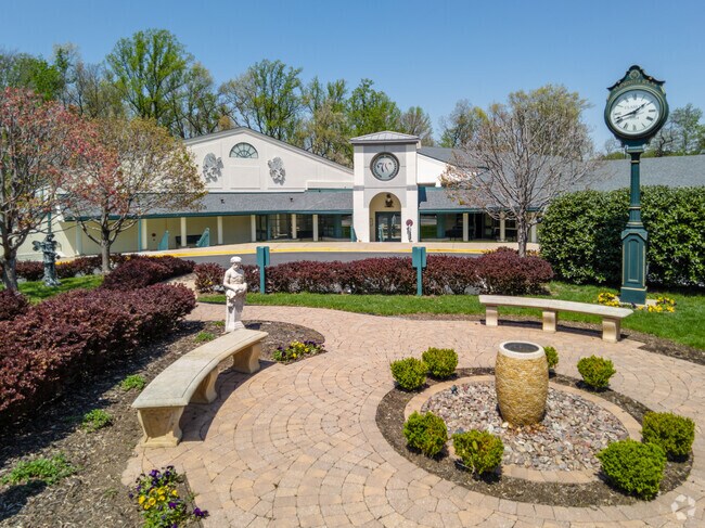 Statues and seating benches are in front of the Westminster School in Annandale, VA.