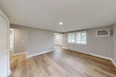Located at 2984 US-11 in La Fayette, NY, this single-floor, 2-bedroom, 1-bathroom home offers a clean, modern aesthetic with quality finishes throughout. The open living room is bright and welcoming, featuring light hardwood floors, neutral gray walls, recessed lighting, and large windows with white blinds that bring in ample natural light. Baseboard heating runs throughout the main living areas, ensuring year-round comfort.

The kitchen is a standout feature, outfitted with white shaker-style cabinetry, granite countertops, and a full suite of stainless steel appliances including a refrigerator, range, microwave, and dishwasher. Recessed lighting and the continuation of hardwood flooring give the kitchen a cohesive, updated feel.

Both bedrooms are comfortably sized, with plush carpeting, neutral tones, and windows overlooking the surrounding landscape. The primary bedroom includes a wall-mounted air conditioning unit for added comfort. Three closets provide generous storage throughout the home.

The bathroom is clean and functional, featuring a tub-shower combination, a granite-topped vanity, and hardwood-style flooring. A patio extends the living space outdoors, offering a pleasant area to relax. The layout flows efficiently, making excellent use of the available space.