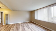 Located at 1530 5th Ave in San Francisco's Inner Sunset neighborhood, this single-floor residence offers a clean, functional layout with a consistent design aesthetic throughout. Light wood-style flooring runs seamlessly across the living areas and bedrooms, contributing to a bright and cohesive feel. Neutral warm-toned walls complement the flooring and create an inviting atmosphere throughout the space.

The living area is generously proportioned, featuring large windows fitted with vertical blinds that allow natural light to filter in. A ceiling fan adds both practicality and character to the dining or transitional area, which connects smoothly to the kitchen. The kitchen is equipped with white cabinetry, speckled countertops, a coil-burner electric range, an over-the-range microwave, and a sink positioned near a window — providing ample storage and functionality.

Bedroom spaces are well-sized with large windows and neutral walls, offering versatility for a variety of uses. At least one bedroom includes a closet with built-in organization. The bathroom features a combined tub and shower with white tile surround, a vanity with under-sink storage, a medicine cabinet mirror, and tile flooring. Additional cabinetry in a utility or laundry area provides extra storage with matching white finishes and speckled countertop surfaces.