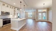 This well-designed two-story residence offers 1430 square feet of living space, with 670 sq ft on the ground floor and 760 sq ft on the upper level. The home boasts 2 bedrooms and 4 bathrooms, providing ample space and privacy for occupants. The primary bedroom is particularly generous at 210 square feet.

The interior is characterized by a neutral color palette with beige walls and crisp white trim, creating a bright and inviting atmosphere. Large windows with white blinds allow abundant natural light to flood the rooms, while offering views of the surrounding area. The living spaces feature high-quality wood-look flooring, adding warmth and durability to the home.

Modern amenities include recessed lighting and a sleek ceiling fan, ensuring comfort and good air circulation. Crown molding adds a touch of elegance to the rooms. The open floor plan likely incorporates a kitchen and living room combination, ideal for contemporary lifestyles. With additional spaces including a hallway, staircase, and two closets, this home offers both functionality and style in a compact yet comfortable package.