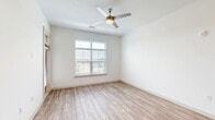 Located in the Grande Dunes N Village community in Longs, SC, this well-appointed 3-bedroom, 2-bathroom single-floor home offers a clean, modern aesthetic throughout. The open-concept kitchen and living area serves as the heart of the home, featuring light wood-look LVP flooring, recessed lighting, and a ceiling fan that anchors the living space. The kitchen is a standout, showcasing gray shaker cabinetry, a white quartz countertop island with an undermount sink, subway tile backsplash, stainless steel appliances, and elegant pendant lighting that flows into the open living area. Natural light pours in through multiple windows fitted with horizontal blinds. The primary bedroom offers a comfortable retreat with plush carpet flooring, a ceiling fan, and a generous walk-in closet equipped with wire shelving systems. Additional bedrooms are carpeted, bright, and feature large windows with outdoor views of the surrounding neighborhood. The bathrooms are finished with wood-look LVP flooring, gray vanity cabinetry, white quartz countertops, and a tiled tub-shower surround. A private exterior door with a transom window adds convenient access from the living area. The overall ambiance is bright, clean, and move-in ready.
