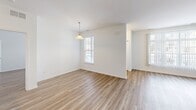 Located on Primrose Lane in Ypsilanti, Michigan, this single-story home offers a well-designed layout with 2 bedrooms and 3 bathrooms. Light-toned wood-look flooring flows throughout the interior, creating a clean and cohesive aesthetic across every room.

The combined living and dining area serves as the heart of the home, anchored by a tile-surround fireplace that adds warmth and character. Large windows allow natural light to fill the space, enhancing its open and airy feel. The kitchen features warm wood cabinetry, dark countertops, and a full suite of black appliances, including a refrigerator, range, and over-the-range microwave.

The primary bedroom is generously sized and includes a walk-in closet outfitted with wire shelving and hanging rods for ample storage. The primary bathroom offers both a standalone shower and a tiled soaking tub with wood-look flooring. The second bedroom is bright and comfortable, with a dedicated closet and a window with natural light. A total of four closets throughout the home provide excellent storage capacity.

A dedicated laundry room houses a full-size washer and dryer with additional shelving. The attached garage features an automatic opener and offers convenient parking and storage. A utility room and entrance area round out this functional and well-appointed home.