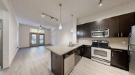 Located at 2616 Bagby Street in Houston's vibrant Montrose neighborhood, this one-bedroom, one-bathroom unit at City Place Montrose offers a well-designed, efficiently laid-out living space. Light wood-style flooring runs throughout, creating a cohesive and contemporary feel.

The open-concept kitchen is a standout feature, equipped with dark espresso cabinetry, granite countertops, a peninsula with a built-in sink, stainless steel appliances including a refrigerator, electric range, microwave, and dishwasher, and stylish pendant lighting. Track lighting enhances the functional flow between the kitchen and living area.

The living room is bright and welcoming, anchored by a set of French doors with transom windows above that invite natural light and provide views of the surrounding greenery. A ceiling fan adds comfort to the space.

The bedroom is generously sized, featuring a large window with natural light and direct access to a walk-in closet outfitted with wire shelving and organizational storage on multiple levels.

The bathroom is clean and functional, offering a tiled tub-shower combination, a dark-framed vanity with a light countertop, a large mirror, and light wood-style flooring consistent with the rest of the unit. A hallway connects the main living areas efficiently, completing this thoughtfully arranged home.