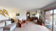 Located at 2220 Pascal St in Roseville, MN, this single-floor unit offers a practical and comfortable layout across several well-defined spaces. The living area is generously proportioned, featuring wall-to-wall carpet, a ceiling fan, and a large sliding glass door that opens to a private patio, allowing natural light to fill the room. A sectional sofa and recliner arrangement creates a welcoming atmosphere suited for relaxing or entertaining.

The galley-style kitchen is efficiently designed with warm wood cabinetry lining both sides, white appliances including a range and refrigerator, and tile flooring. Adjacent to the kitchen is a versatile room currently used as both a dining area and home office, featuring dual windows that bring in natural light, a ceiling fan, wall-mounted shelving, and a wall AC unit.

Two carpeted bedrooms each include ceiling fans and wall-mounted AC units. The primary bedroom offers ample floor space with a window view, while the second bedroom also features a sliding window. Both rooms provide comfortable, functional layouts.

The full bathroom includes a white vanity, tiled flooring, and a shower/tub combination. The overall ambiance of the unit is casual and functional, with a consistent neutral color palette throughout.