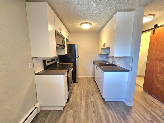 Kitchen with all of the amenities to bring out your inner chef with real-tile backplashes! - 12th and Wads Residences