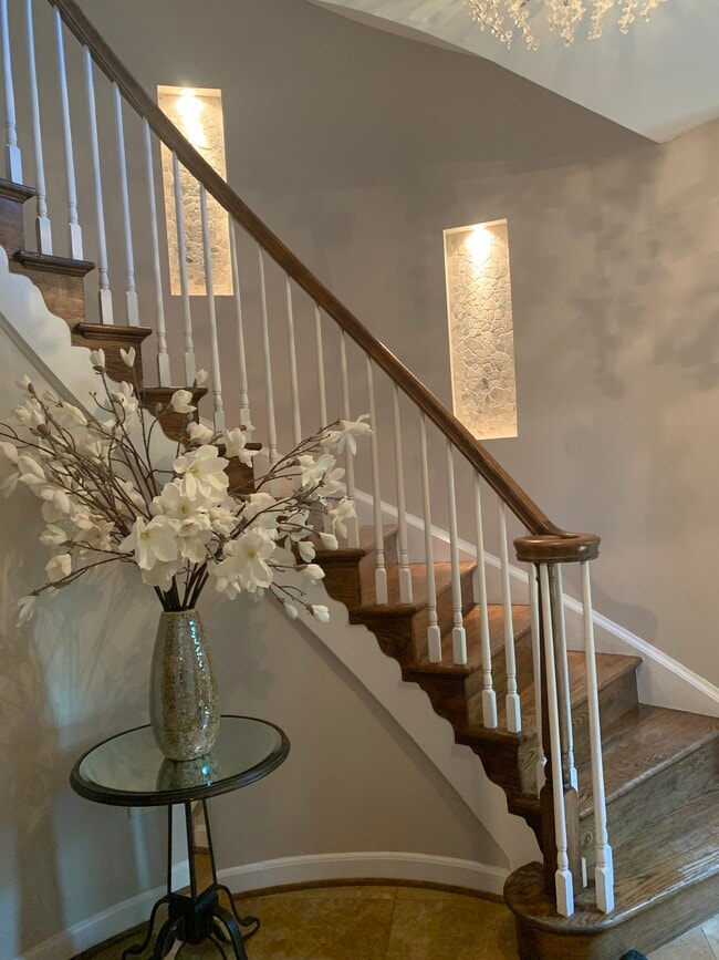 Entry with spiral stairs throughout and built in stone accents. - 2367 S Queen St Townhome
