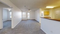 Located at 300 Peachtree Dr in Nixa, Missouri, this single-story, 3-bedroom, 2-bathroom home offers a practical and comfortable layout. The combined living and dining area is bright and open, featuring plush carpet flooring, a ceiling fan, a textured ceiling, and a glass-paneled door that brings in natural light. The kitchen is well-appointed with light wood cabinetry, warm laminate countertops, a central island with additional counter space, white appliances including a refrigerator, range, and microwave, and durable hardwood-style flooring. A pendant light over the adjoining dining counter adds a welcoming touch. The spacious primary bedroom includes carpet flooring, a ceiling fan, and a private en-suite bathroom with a tub-shower combo and tile flooring. Two additional bedrooms each feature carpet, ceiling fans, and windows that allow natural light. The second full bathroom also features a tub-shower combo and tile flooring. A dedicated in-unit laundry room and a utility room add everyday convenience. With five closets distributed throughout, storage is abundant. The home's clean, neutral palette and functional design make it a versatile and move-in-ready space.