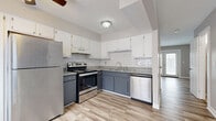 Located at 160 Hayes St in Delaware, Ohio, this two-story home offers a practical and comfortable layout across two floors. The main level hosts the kitchen and primary living areas, while the upper floor provides additional bedroom space. The kitchen is a standout feature, showcasing a two-tone cabinet design with crisp white upper cabinets and slate-gray lower cabinets, granite-look countertops, a classic white subway tile backsplash, and a full suite of stainless steel appliances including a refrigerator, electric range, and dishwasher. Light wood-look flooring runs throughout the kitchen and main living areas, complemented by a ceiling fan that adds to the airy feel. Natural light filters in through window blinds, keeping the space bright and inviting. The four bedrooms are finished with neutral-toned carpet and painted in soft, warm gray tones, providing a calm and restful atmosphere. The two bathrooms are clean and functional — one featuring beige tile flooring with a vanity and toilet, and the other with a full tub-shower combination. Connecting the floors are two staircases and hallways that ensure smooth flow throughout the home. Textured ceilings add a classic touch to the overall design.