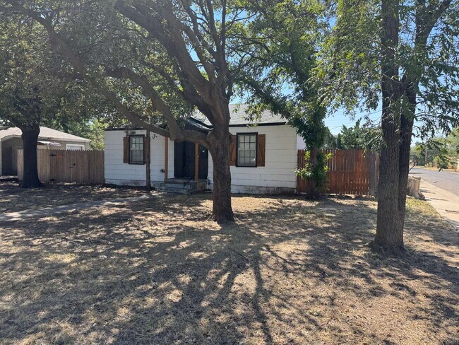 Foto del edificio - "Charming 4-Bed Lubbock Retreat: Granite Kitchen, Hardwood Elegance & Cozy Fireplace!"