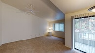 Located on Polo Club Drive in Farmington Hills, Michigan, this single-floor residence offers a well-organized layout with a neutral, light-filled interior throughout. The living area is a standout feature, showcasing vaulted ceilings that lend a sense of openness and volume to the space. A ceiling fan is centrally mounted, and windows fitted with vertical blinds allow natural light to filter in, creating a bright and airy atmosphere. Soft carpeting covers the floors throughout the living and bedroom areas.

The kitchen is efficiently designed with white cabinetry featuring wood-tone trim, light countertops, and hardwood flooring. A pendant light hangs above the workspace, and a window above the sink provides additional natural light. Appliances including a refrigerator and dishwasher are included.

The bedrooms are generously proportioned, each carpeted and equipped with windows offering outdoor views. One bedroom includes a walk-in style closet with built-in shelving alongside an additional closet, providing ample storage.

Two bathrooms serve the unit. One features a full tub-shower combination with white tile surround, while the other offers a wide vanity with a large mirror, light countertops, and tile flooring, with a separate shower visible in the reflection.