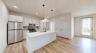 This well-appointed one-bedroom, one-bathroom unit in Sherman, TX offers a thoughtfully designed layout with modern finishes throughout. Light wood-look flooring flows through the open-concept living, dining, and kitchen area, creating a bright and cohesive feel. The kitchen is a standout feature, showcasing light wood cabinetry, a subway tile backsplash, stainless steel appliances including a refrigerator, microwave, and range, and a white quartz-topped island with an undermount sink and pendant lighting overhead. The living area benefits from abundant natural light through multiple windows and a glass door leading to the private balcony, complemented by a ceiling fan. The bedroom is carpeted for comfort, features its own ceiling fan, generous natural light from dual windows with outdoor views, and direct access to two closets with built-in shelving and hanging rods. The bathroom is clean and contemporary, offering a granite-topped vanity with white cabinetry, a tub and shower combo with full tile surround, and wood-look flooring. Additional conveniences include a dedicated laundry area and utility room, rounding out this functional and stylish unit.
