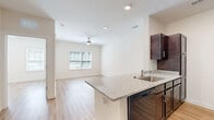 This one-bedroom, one-bathroom unit at 4947 Stewart Mill Rd in Douglasville, GA offers a well-designed, single-level layout that makes efficient use of its space. The open-concept kitchen and living area serves as the heart of the home, featuring rich dark wood cabinetry, granite countertops, a breakfast bar peninsula with an undermount sink, and a full suite of black and stainless steel appliances including a refrigerator, range, microwave, and dishwasher. Light hardwood-style flooring runs throughout the unit, lending a clean, cohesive aesthetic to every room. The living area is bright and open, flowing naturally from the kitchen. The bedroom is a comfortable, well-proportioned retreat with two windows that allow ample natural light and a ceiling fan for added comfort. A dedicated closet provides convenient storage. The bathroom is finished with a dark wood vanity, granite countertop, undermount sink, a large mirror, and modern brushed nickel fixtures, complemented by the same light flooring found throughout the unit. Neutral wall tones and clean white trim complete the modern, move-in-ready feel of this thoughtfully appointed home.