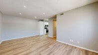 Located at 601 E 8th St in Azusa, California, this 2-bedroom, 1-bathroom unit offers a thoughtfully laid-out single-floor plan finished with contemporary touches throughout. Light wood-style vinyl flooring flows consistently through every room, complemented by soft gray walls and crisp white trim, creating a clean, cohesive aesthetic.

The combined kitchen and living area forms the heart of the unit. The kitchen is appointed with white shaker-style cabinetry, light countertops, a stainless steel sink, and a full suite of stainless steel appliances including a gas range, microwave, and refrigerator. A skylight adds brightness to the cooking space, which opens conveniently toward the living area.

The living room benefits from a large window dressed with vertical blinds, allowing ample natural light and views of greenery outside. Textured ceilings and recessed lighting add character to the space.

The primary bedroom is a comfortable size, with direct access to a dedicated walk-in closet featuring built-in shelving and hanging rods — a standout storage feature. The second bedroom also includes a window with vertical blinds and its own closet access.

The bathroom is well-appointed with a white vanity featuring a marble-style countertop, brushed nickel hardware, and a full tub-shower combination. A hallway connects the rooms efficiently, completing this well-organized and move-in-ready home.