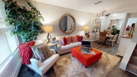 Located at 801 Mill Stream Lane in Lynchburg, Virginia, this two-story home offers a thoughtfully arranged layout across two levels. The main living area serves as a central gathering space, featuring hardwood-style flooring, a textured ceiling, and a ceiling fan. A large round mirror with a wooden frame anchors the main wall, complementing the warm, inviting atmosphere. Natural light filters in through windows dressed with blinds, illuminating the open layout that connects to a dining area.

The kitchen is equipped with warm oak cabinetry, dark granite-style countertops, a stainless steel sink, and a white electric range. A window above the counter provides natural light and a view of the surrounding greenery.

The bedrooms are carpeted and well-proportioned, each featuring windows with blinds that allow ample natural light. The rooms offer sufficient space for full bedroom furniture arrangements and display a neutral color palette that lends a calm, restful ambiance.

The bathroom includes a vanity with a wide mirror, a lighted fixture above, and textured, patterned walls that add visual interest. A staircase connects the two floors, contributing to the functional flow of the overall layout.