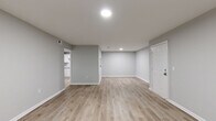 This well-appointed 2-bedroom, 2-bathroom single-story home at 500 Hambrick Rd in Stone Mountain, GA offers a clean, modern aesthetic throughout. The open living and dining areas are finished with light-toned luxury vinyl plank flooring and neutral gray walls, creating a bright and welcoming atmosphere. Large windows flank the front entry door, flooding the space with natural light and offering views of the surrounding greenery.

The kitchen is thoughtfully updated with crisp white shaker-style cabinetry, granite countertops, a subway tile backsplash, and stainless steel appliances including a range, dishwasher, and refrigerator — providing both style and functionality.

Both bedrooms are carpeted for comfort, with the generously sized primary bedroom offering ample space. Each bedroom is served by a closet with slatted bifold doors and built-in wire shelving. The two bathrooms are finished with white vanities, granite countertops, undermount sinks, and tub/shower combinations with clean white surrounds.

Connecting hallways and utility spaces complete the efficient and practical layout. With four closets distributed throughout, storage is abundant. The home's consistent use of updated materials and a neutral color palette lends a fresh, move-in-ready feel throughout every room.