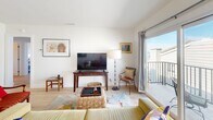 This charming 840 square foot home in San Clemente, California offers a perfect blend of coastal living and modern comfort. The single-story layout includes two bedrooms, one bathroom, and an open-concept living area that maximizes the use of space.

Upon entering, you're greeted by a bright and airy living room featuring large sliding glass doors that lead to a balcony, offering glimpses of the ocean beyond. The room is tastefully decorated with a comfortable sectional sofa, woven rattan coffee table, and eclectic artwork that adds character to the space.

The kitchen, while compact, is efficiently designed with sleek white cabinetry, stainless steel appliances, and a gas range. Light wood flooring throughout the home creates a cohesive and inviting atmosphere.

The primary bedroom, measuring 170 square feet, boasts a striking teal upholstered headboard and large windows that frame the ocean view. A ceiling fan ensures comfort on warmer days. The second bedroom, equally well-appointed, features sliding glass doors and ample natural light.

The bathroom is modern and functional, with a glass-enclosed shower, spacious vanity, and neutral tones that complement the home's overall aesthetic.

Throughout the property, carefully chosen decor elements, including coastal-inspired artwork and pops of color, enhance the beachy feel of this delightful San Clemente home. The combination of location, layout, and design makes this property an ideal seaside retreat.