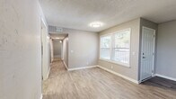 Located at 488 Lemont Dr in Nashville, TN, this single-floor 2-bedroom, 3-bathroom home offers a well-organized layout with modern finishes throughout. The living room welcomes you with wood-look laminate flooring, neutral gray walls, a textured ceiling, and a front-facing window that brings in natural light. The kitchen stands out with crisp white shaker cabinets, white subway tile backsplash, light quartz countertops, a stainless steel sink, and a dishwasher — combining style and functionality efficiently. A connecting hallway with light wood-look flooring links the main living areas to the bedrooms and bathrooms. Both bedrooms feature plush carpeting, ceiling fans, and closets, with the primary bedroom offering additional doors leading to an en-suite bathroom and extra storage. The bathrooms are cleanly finished with white vanity cabinets, subway tile accents, light wood-look tile flooring, and brushed nickel hardware. Windows in the bedrooms provide outdoor views and natural light. The overall aesthetic is consistent and contemporary, with a neutral gray-and-white palette, clean white trim, and updated fixtures carried throughout every room, creating a cohesive and move-in ready living environment.