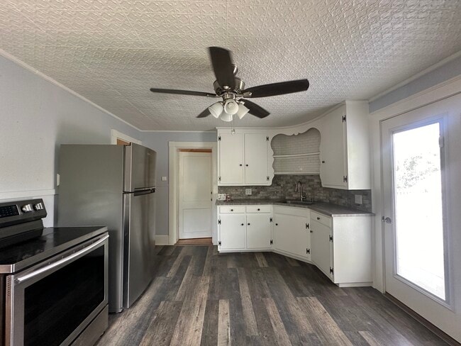 Full kitchen with range, refrigerator, and pantry space - 363 Concord Rd