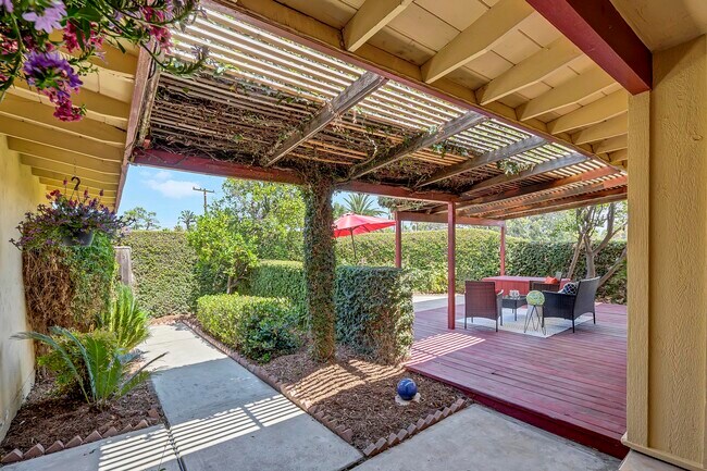 Garden entry with living green walls and covered entertainment deck. - 8055 Morocco Dr