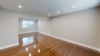 Located at 3500 Barrett Dr in Kendall Park, NJ, this thoughtfully renovated single-floor residence showcases a clean, contemporary aesthetic throughout. Rich hardwood flooring flows through the generously sized living and bedroom areas, reflecting recessed lighting and natural light admitted through well-placed windows. The neutral gray wall palette creates a bright, cohesive atmosphere that complements the warm wood tones underfoot.

The kitchen is a standout feature, outfitted with dark espresso shaker cabinetry, crisp white countertops, a tasteful subway tile backsplash, and a full suite of stainless steel appliances including a gas range, dishwasher, and refrigerator. Light-toned tile flooring grounds the space with a modern touch.

Bedrooms are well-proportioned, each offering closet storage with built-in shelving and easy access to adjacent spaces. A hallway with light tile flooring and additional closet access provides a practical transition between rooms.

The bathroom is elegantly appointed with large-format marble-look tile wrapping the soaking tub surround from floor to ceiling, complemented by a frosted window that provides privacy while allowing natural light to filter in. A recessed niche adds both style and function.

Overall, this space presents a polished, move-in-ready environment with modern upgrades throughout.