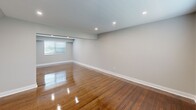 Located at 3500 Barrett Dr in Kendall Park, NJ, this thoughtfully renovated single-floor residence showcases a clean, contemporary aesthetic throughout. Rich hardwood flooring flows through the generously sized living and bedroom areas, reflecting recessed lighting and natural light admitted through well-placed windows. The neutral gray wall palette creates a bright, cohesive atmosphere that complements the warm wood tones underfoot.

The kitchen is a standout feature, outfitted with dark espresso shaker cabinetry, crisp white countertops, a tasteful subway tile backsplash, and a full suite of stainless steel appliances including a gas range, dishwasher, and refrigerator. Light-toned tile flooring grounds the space with a modern touch.

Bedrooms are well-proportioned, each offering closet storage with built-in shelving and easy access to adjacent spaces. A hallway with light tile flooring and additional closet access provides a practical transition between rooms.

The bathroom is elegantly appointed with large-format marble-look tile wrapping the soaking tub surround from floor to ceiling, complemented by a frosted window that provides privacy while allowing natural light to filter in. A recessed niche adds both style and function.

Overall, this space presents a polished, move-in-ready environment with modern upgrades throughout.