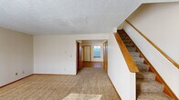 Located at 372 James Way in Marion, Ohio, this two-story home offers three bedrooms and three bathrooms across two thoughtfully laid out floors. The main level features a carpeted living room with a wood-railed staircase, a hallway connecting to additional rooms, and a well-appointed kitchen outfitted with warm oak cabinetry, a double sink, and white appliances including a gas range and refrigerator. Wood-look flooring runs through the kitchen and entry areas, while plush carpet covers the living and bedroom spaces throughout. The upper floor houses the bedrooms, each featuring neutral walls, carpet flooring, and individual windows that bring in natural light. The generously sized primary bedroom offers a comfortable retreat with ample floor space. Two additional bedrooms provide flexible options for guests, a home office, or other uses. Three full bathrooms, each featuring a tub/shower combo, toilet, and vanity with mirror, serve the household conveniently. Additional spaces include a dedicated laundry area, a closet for storage, and two hallways ensuring smooth flow between rooms. Textured ceilings and consistent neutral tones throughout give the home a clean, move-in-ready appearance.