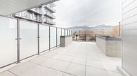 This contemporary 53 square meter apartment in Kelowna, BC, offers a thoughtful blend of style and functionality. The space features two bedrooms and two bathrooms, with the primary bedroom measuring 11 square meters. The open-concept design seamlessly integrates the kitchen and living room, creating a spacious feel within the compact layout.

Light wood flooring runs throughout, complementing the crisp white walls and modern fixtures. The kitchen boasts sleek cabinetry, stainless steel appliances, and a central island with seating, perfect for casual dining or entertaining. Large windows and sliding glass doors flood the living area with natural light and provide stunning mountain views.

Both bedrooms are well-proportioned, with the primary bedroom featuring a picturesque window overlooking the surrounding landscape. The bathrooms are elegantly appointed with modern vanities, ample storage, and stylish fixtures.

A standout feature is the generous balcony, offering an extension of the living space and a perfect spot to enjoy the outdoors. The apartment complex also includes shared amenities such as a rooftop terrace with panoramic views of the city and mountains.

Located at 169 Rutland N rd in Kelowna, this apartment combines urban convenience with natural beauty, making it an ideal residence for those seeking a contemporary lifestyle in a scenic setting.