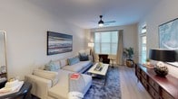Located in Charlotte, NC (28278), this single-floor residence offers a thoughtfully designed layout that balances functionality with modern style. The kitchen is a standout feature, showcasing rich dark-espresso shaker cabinetry reaching toward the ceiling for ample storage, light granite countertops, a full suite of stainless steel appliances including a refrigerator, range, microwave, and dishwasher, and light wood-style flooring that flows seamlessly into the open living area. The living room is bright and welcoming, featuring a ceiling fan with light fixture, a large window dressed with layered blinds and curtains that invite natural light, and neutral walls that complement a variety of décor styles. The bedroom offers plush carpeting underfoot, a ceiling fan, and a generously sized window with sheer curtains, creating a calm and restful retreat. The bathroom is clean and functional, featuring wood-style flooring, a walk-in shower with tile surround, granite-topped vanity with dark cabinetry, and brushed nickel fixtures. Throughout the space, the consistent use of light tones, modern finishes, and practical design details create a cohesive and comfortable living environment.