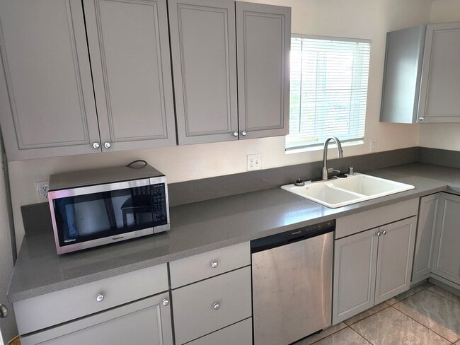 Kitchen includes microwave and dishwasher. - The Junipero Palm Springs